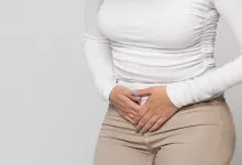 woman suffering from stomach pain feeling abdominal pain cramps period menstruation 1600x900