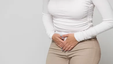 woman suffering from stomach pain feeling abdominal pain cramps period menstruation 1600x900
